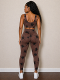 Person wearing a brown patterned sports bra and leggings set against a beige wall.