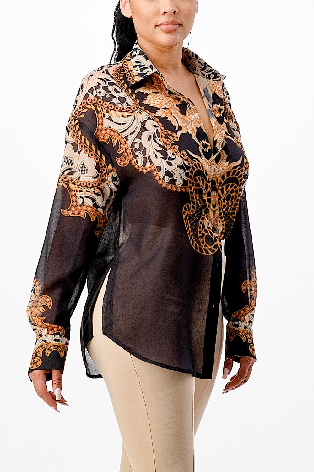 Woman wearing a patterned blouse with sheer overlay on a white background