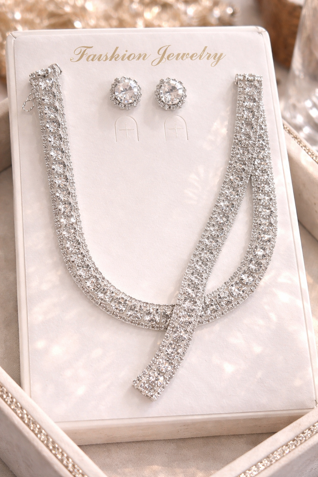 Silver necklace and earrings set on a 'Fashion Jewelry' card.