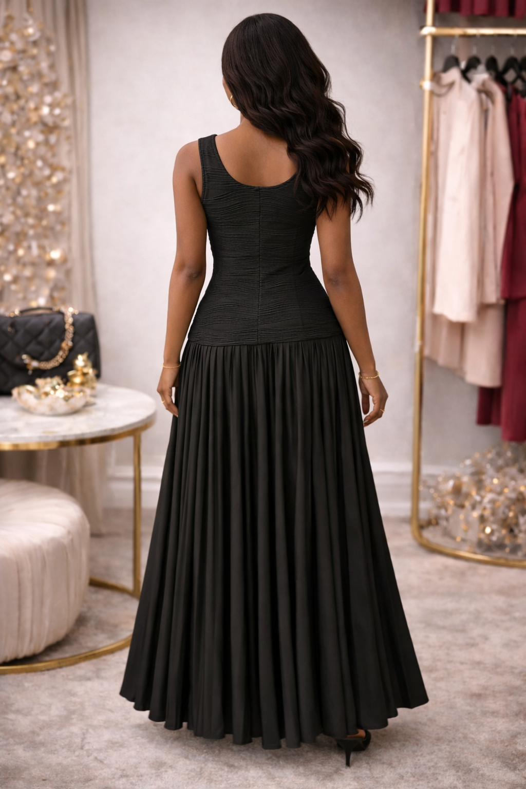 Woman wearing a black dress in a room with decor elements.