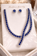 Jewelry set with blue stones on a white card labeled 'Fashion Jewelry'.