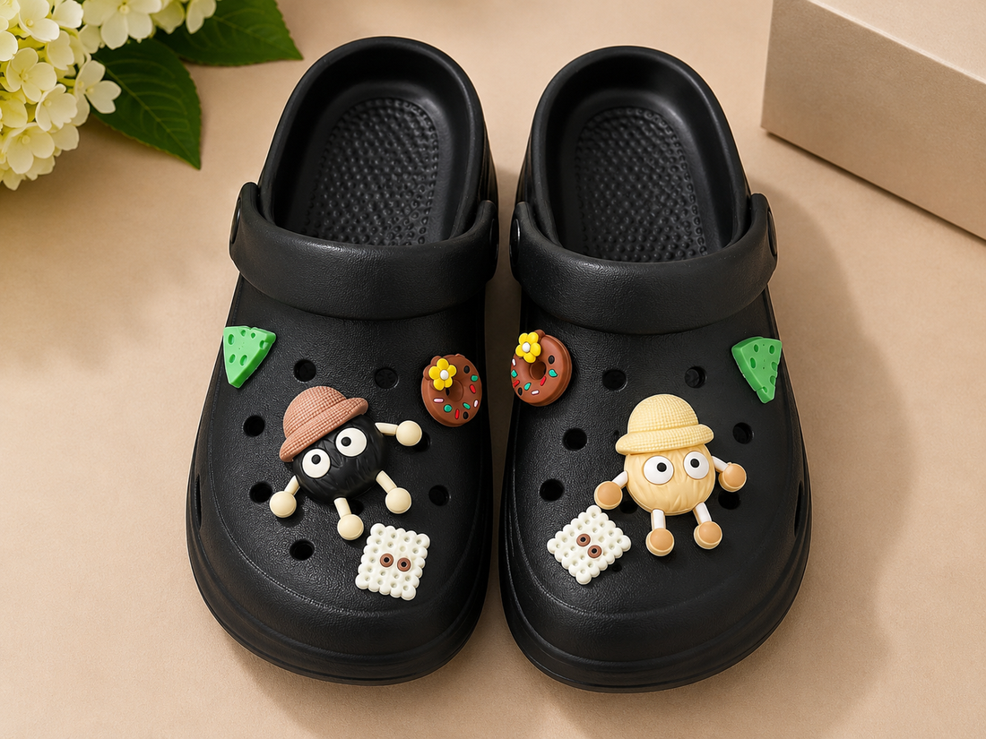 Beige clogs with decorative charms on a beige surface
