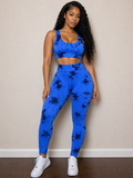 Woman wearing a blue athletic outfit with black patterns against a beige wall.