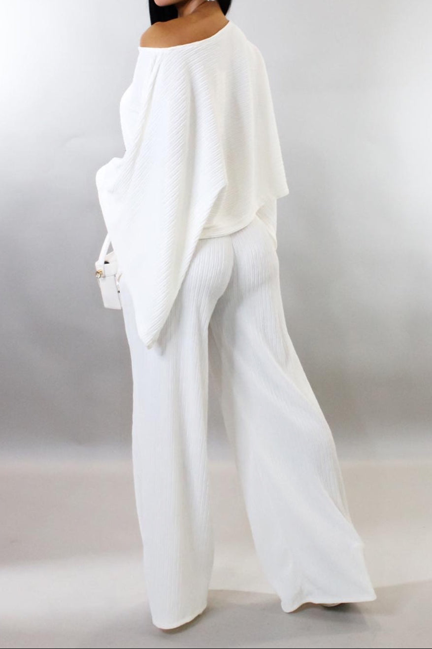 Woman wearing a white outfit with a plain background