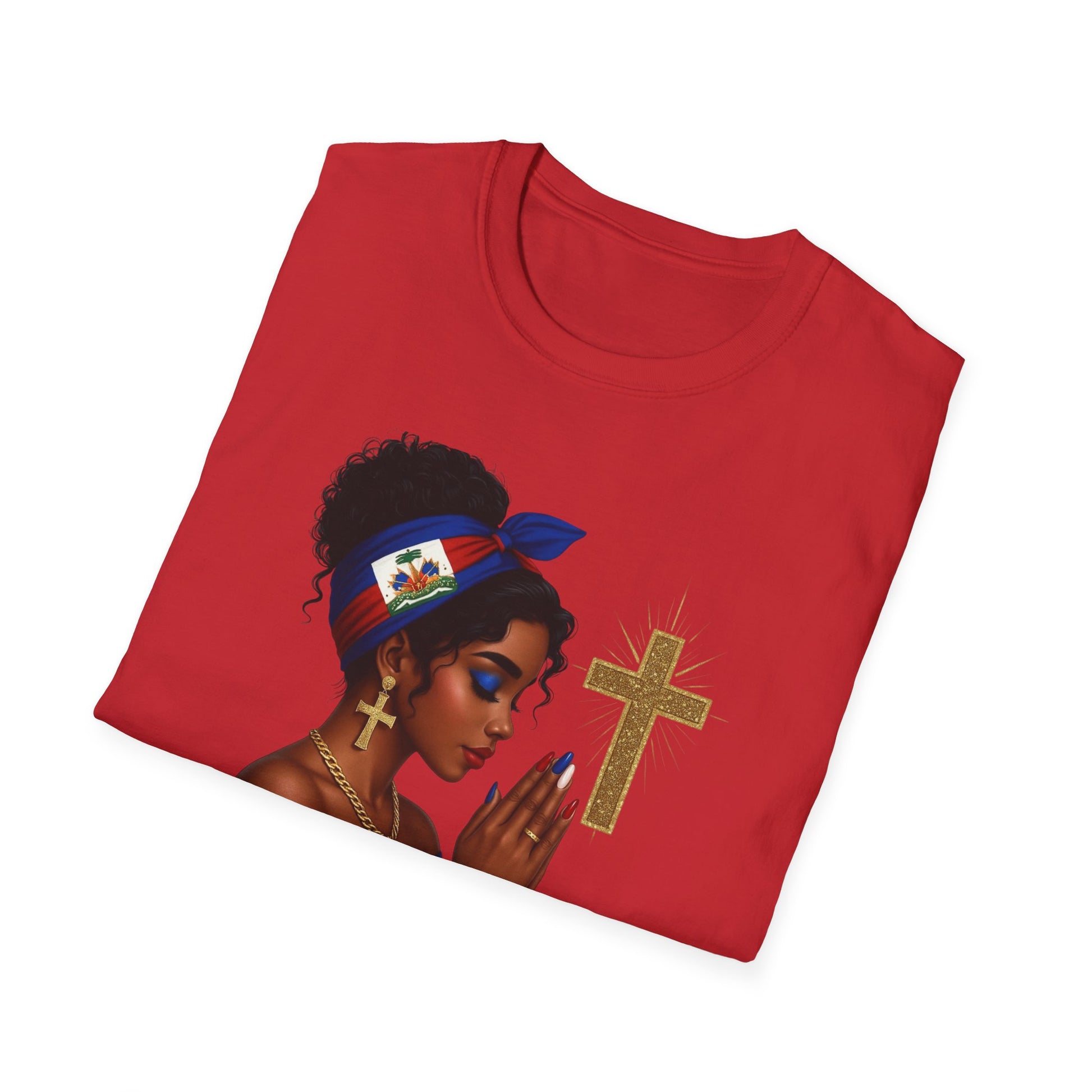 Folded red t-shirt with a graphic of a woman holding a cross on a white background