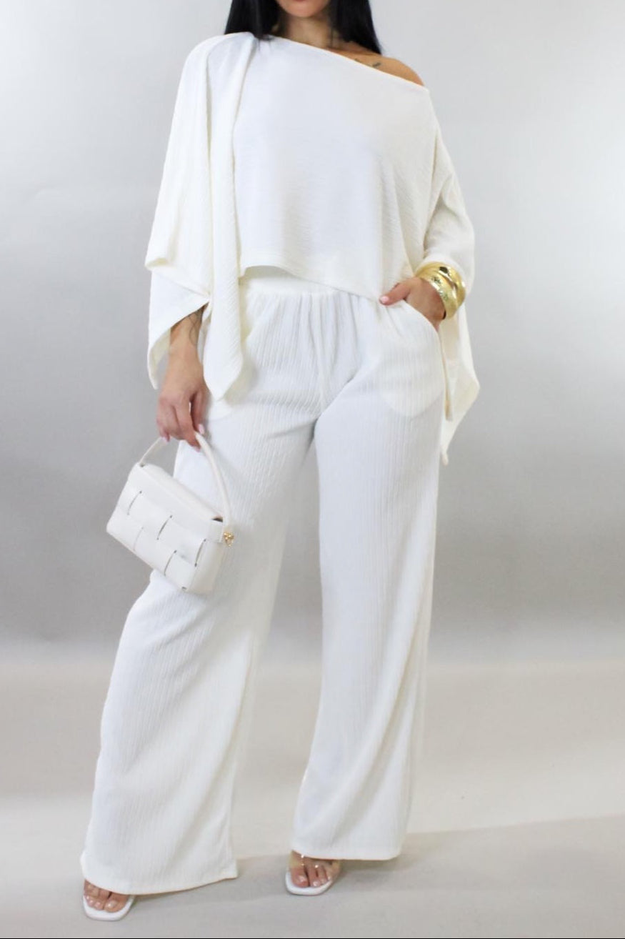 Woman wearing a white outfit with a plain background