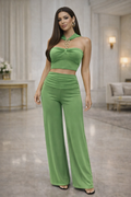 Woman wearing a green outfit in an elegant indoor setting