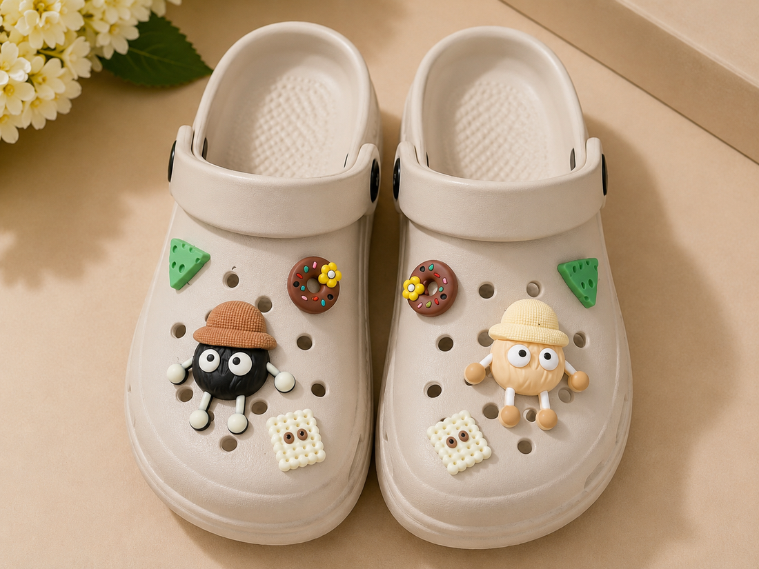 Beige clogs with decorative charms on a beige surface