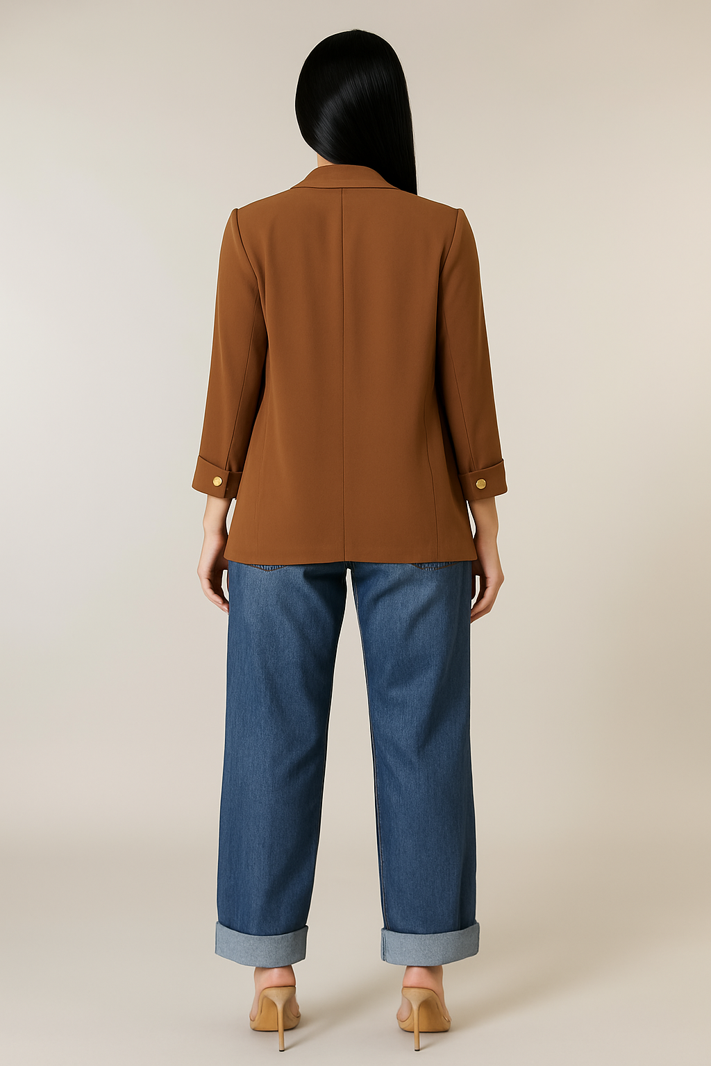 Person wearing a brown jacket and blue pants on a beige background