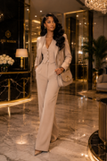 “Woman walking in beige suit carrying beige Luxe Maison leather crossbody bag in luxury hotel lobby”