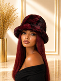 Woman wearing a burgundy fur hat in an elegant interior setting