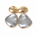 Gold and silver teardrop-shaped earrings on a white background