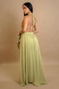 Woman wearing a light green dress with a beige background