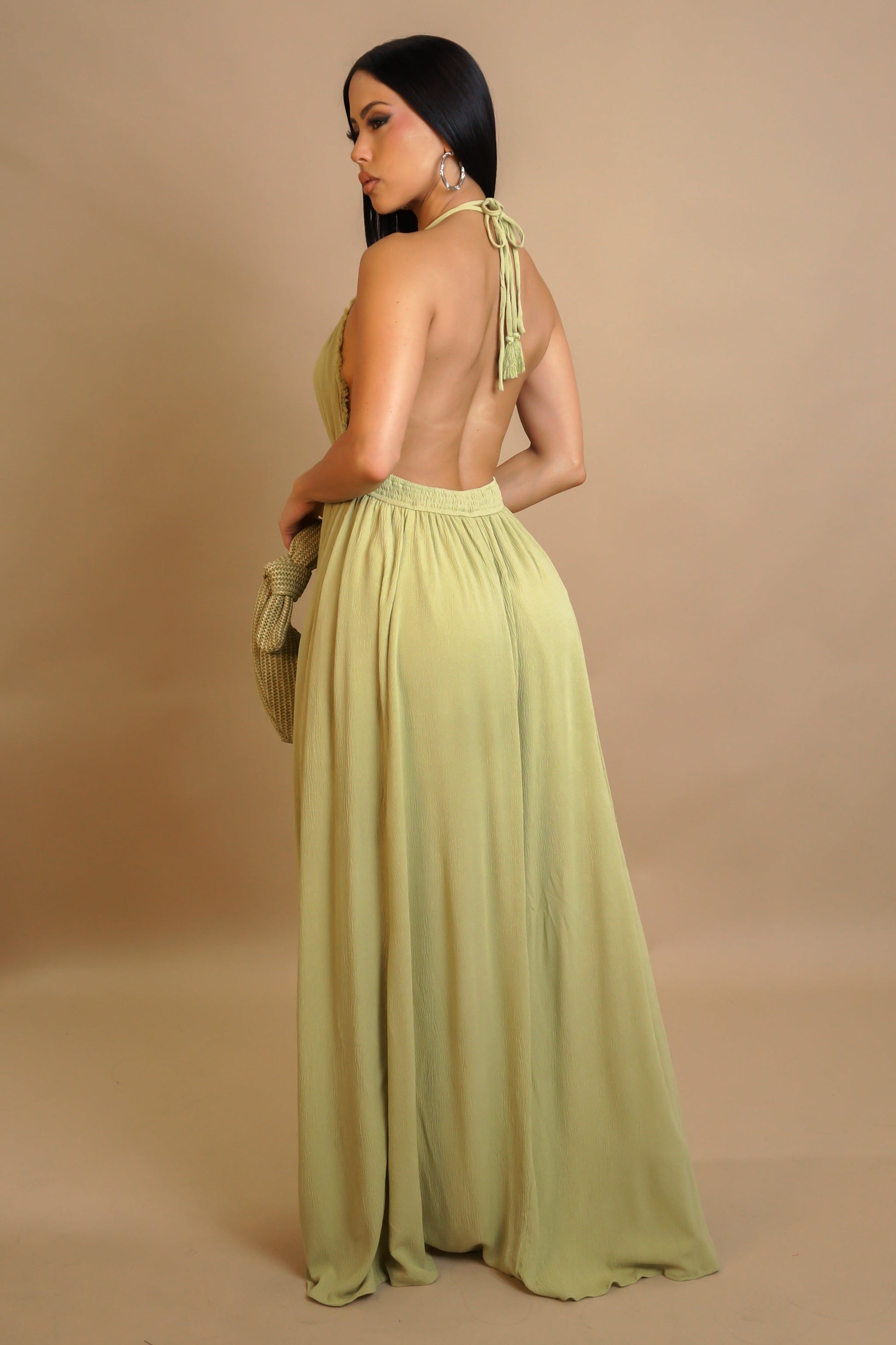 Woman wearing a light green dress with a beige background
