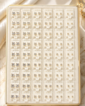 Collection of earrings on a display card with a marble background