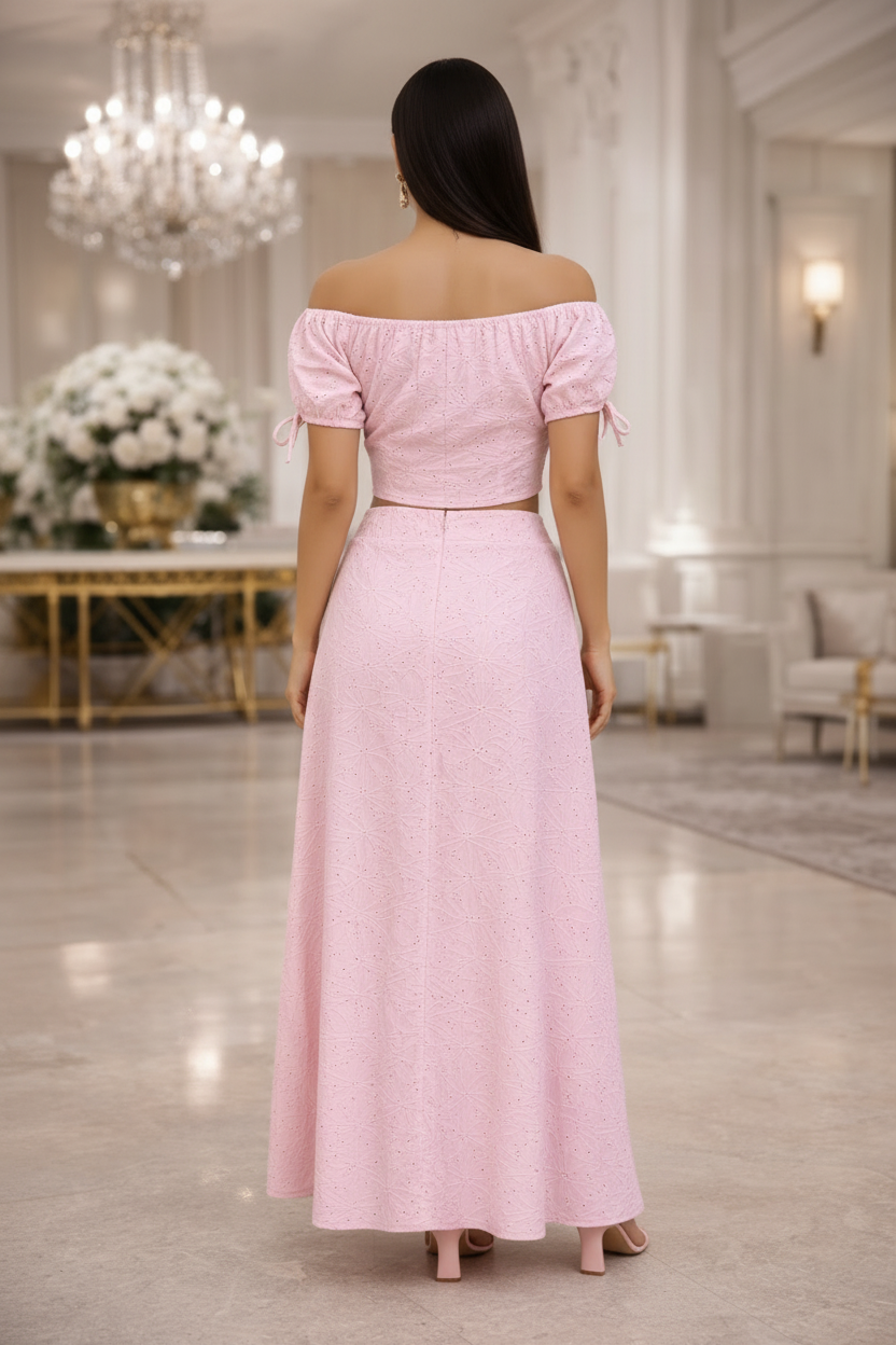 Woman wearing a pink outfit with buttons in an elegant indoor setting