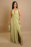 Woman wearing a long green dress against a beige background