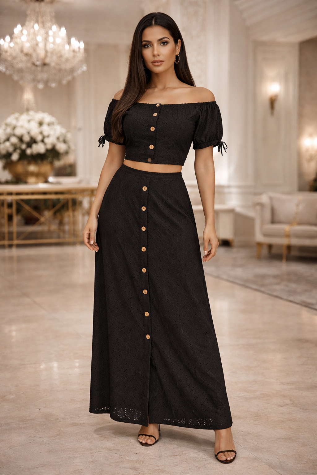 Woman wearing a black outfit with button details in an elegant indoor setting