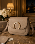 “Beige leather Luxe Maison crossbody bag with gold horseshoe buckle on marble table with authenticity card”