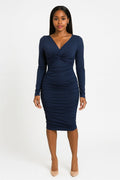 Woman wearing a navy blue dress on a white background