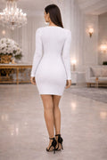 Woman in a white dress standing in an elegant indoor setting