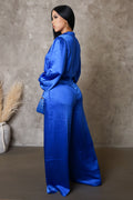 Woman wearing a blue outfit against a neutral background