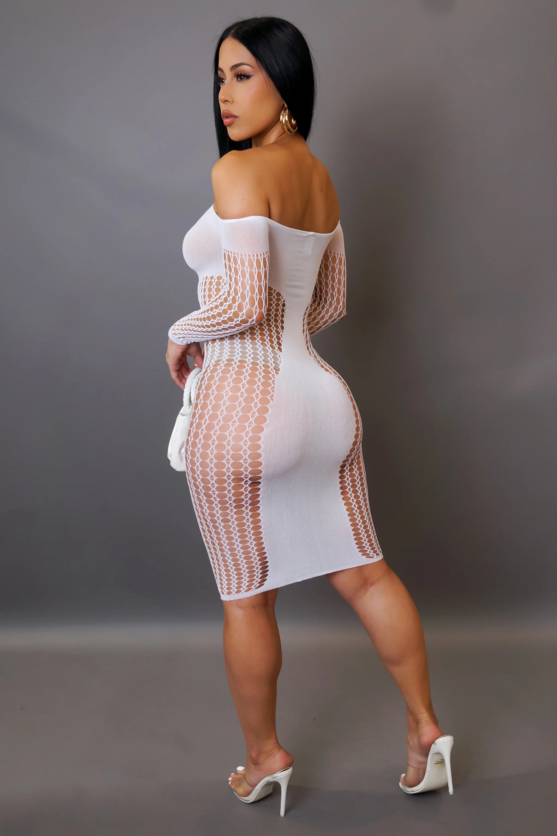 Woman wearing a white and brown mesh dress against a gray background