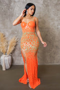 Woman wearing an orange lace dress with a gray background