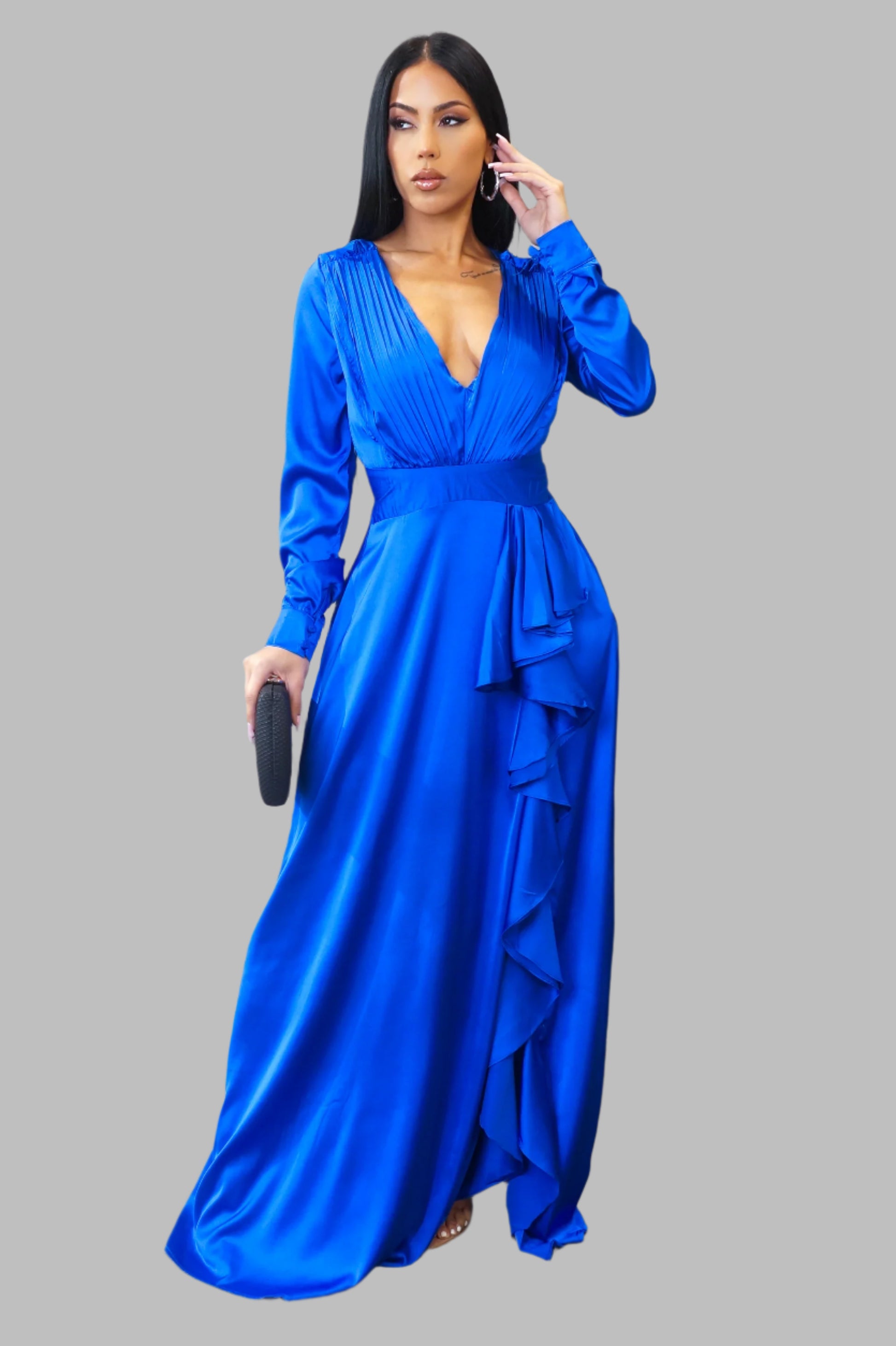 Woman wearing a blue evening gown on a gray background