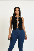 A woman modeling a black sleeveless halter-style top with three front cutouts tied with silver bow details, paired with blue jeans, against a plain light background.