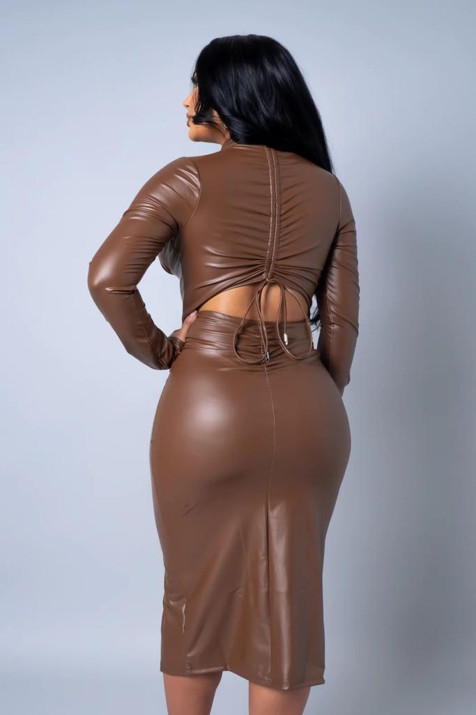 Brown leather dress worn by a person on a light gray background