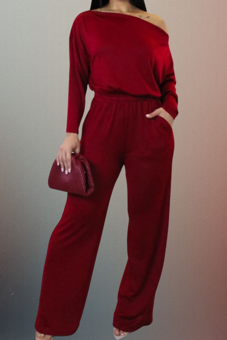 Person wearing a red outfit with a matching handbag against a gradient background